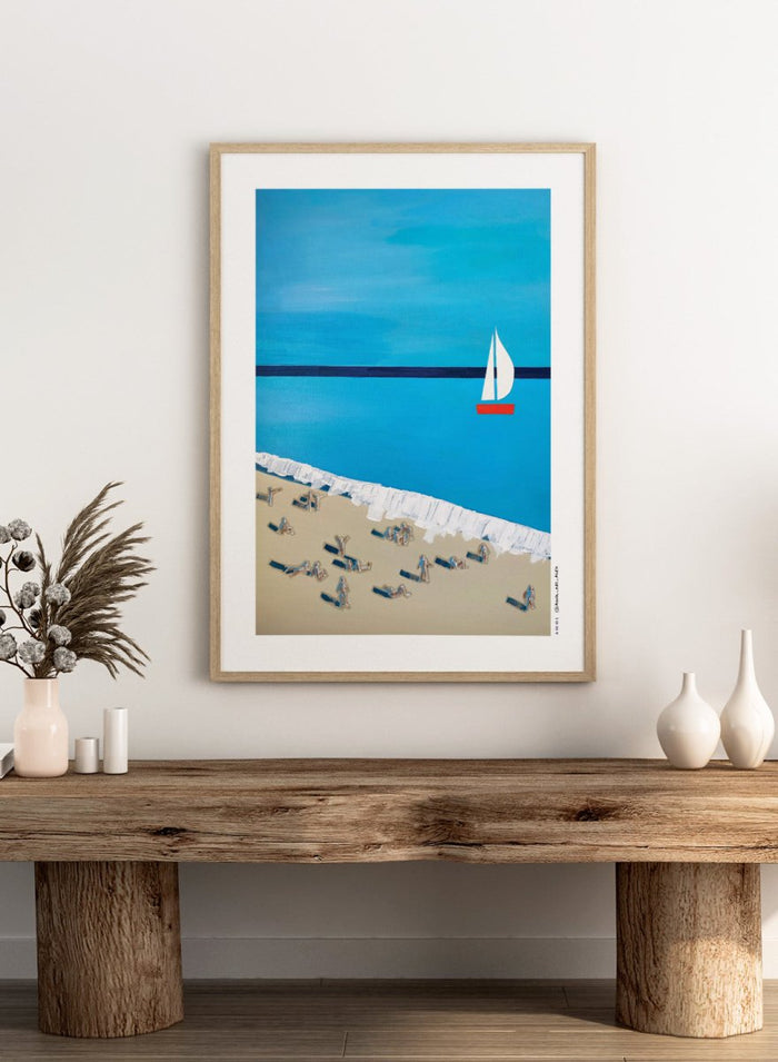 Minimalist Beach Day by Awol Art Alex is a modern coastal art print featuring tiny beachgoers, blue water, white waves, and a red sailboat.