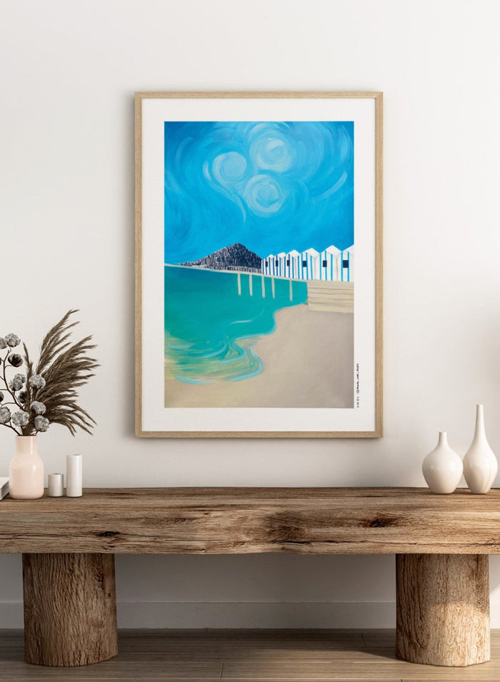 Vibrant Coastal Huts by Awol Art Alex is a modern coastal art print featuring striped beach huts, turquoise water, bold blue sky, and graphic seaside style.