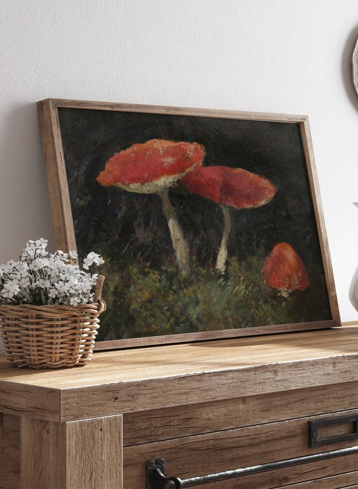 Amanitas by Gustav Macoun is a vintage still life print of red mushrooms in dark forest moss, a woodland nature print great for a rustic wall art collection.