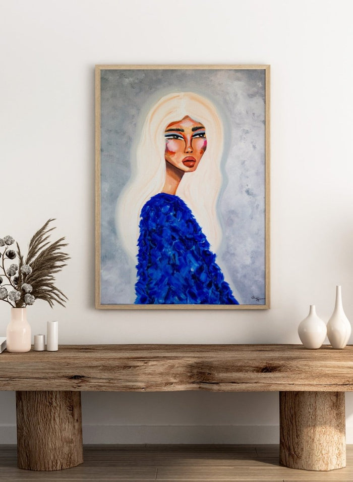 Artistic depiction of a woman with long blonde hair wearing a blue textured garment against a gray background. Elegant Blue Fashion by Amy Straley is a contemporary figurative art print featuring a feminine portrait, bold blue tones, and expressive modern artwork.