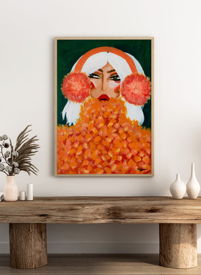 An expressive portrait painting of a woman with white hair, a bright orange headband, large coral-pink pom-pom ear muffs, and a voluminous orange textured coat against a dark green background. Shop Glamorous Orange Earmuffs by Amy Straley, a bold figurative portrait wall art print featuring a stylish woman, orange fashion details, and rich color.
