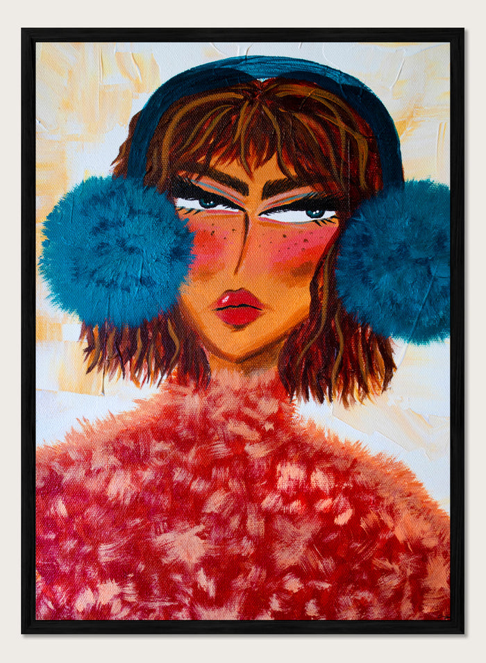 A stylized portrait painting of a woman with brown hair, a dark blue head covering, large bright blue pom-pom ear muffs, and a textured red fuzzy garment, set against a warm cream background. Shop Sassy Earmuffs Portrait by Amy Straley, a contemporary figurative wall art print featuring a bold woman portrait, blue earmuffs, and vivid pink and red tones.