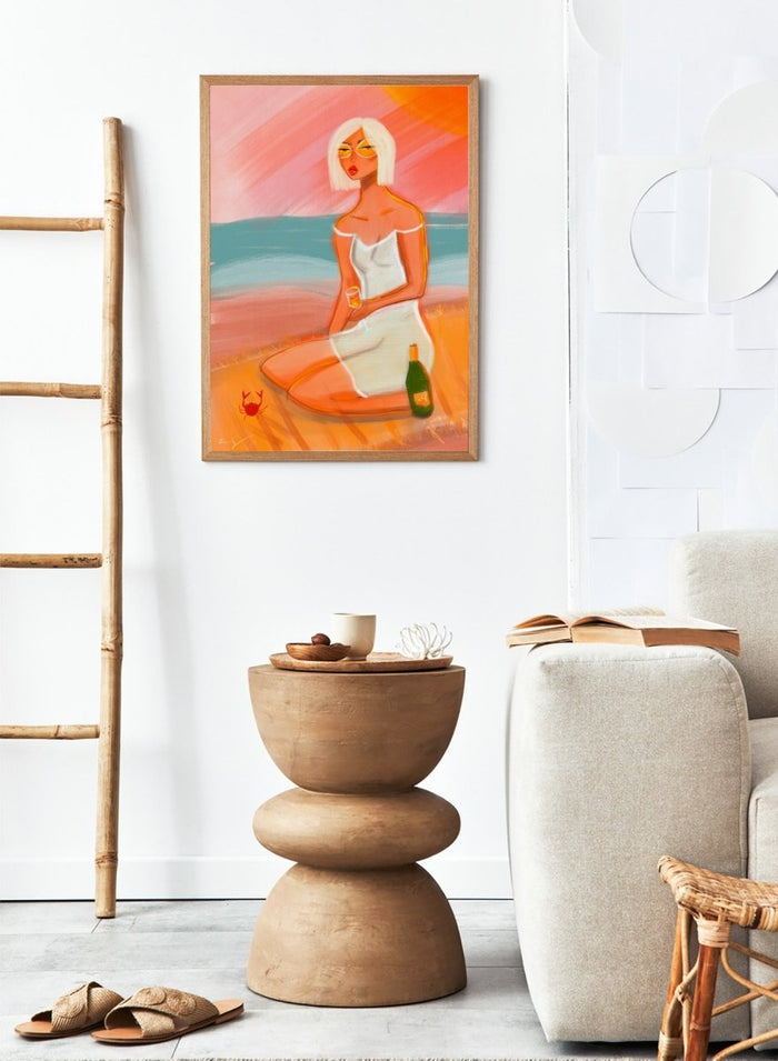 Artistic illustration of a woman sitting on a beach with a sunset background. Sunset Beach Woman by Amy Straley is a contemporary figurative art print featuring a feminine coastal portrait, sunset colors, and modern expressive artwork.