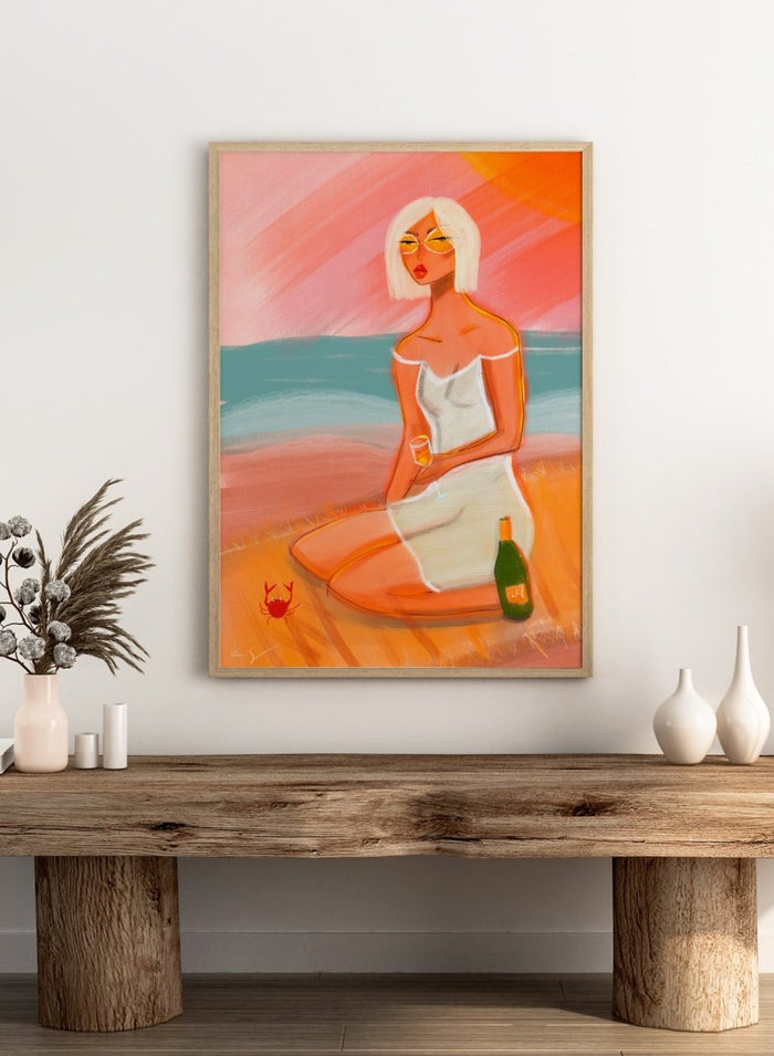 Artistic illustration of a woman sitting on a beach with a sunset background. Sunset Beach Woman by Amy Straley is a contemporary figurative art print featuring a feminine coastal portrait, sunset colors, and modern expressive artwork.