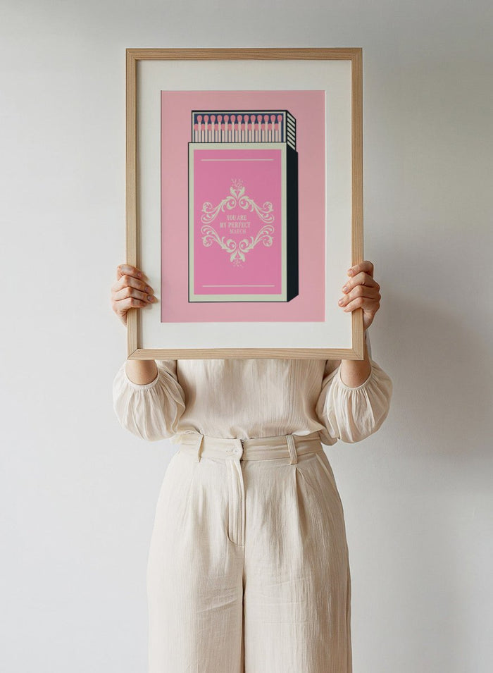 Matchbox with decorative design and text on a pink background. My Perfect Match by Andreas Magnusson is an officially licensed art print featuring a pink matchbox and playful typography. Modern graphic love poster.