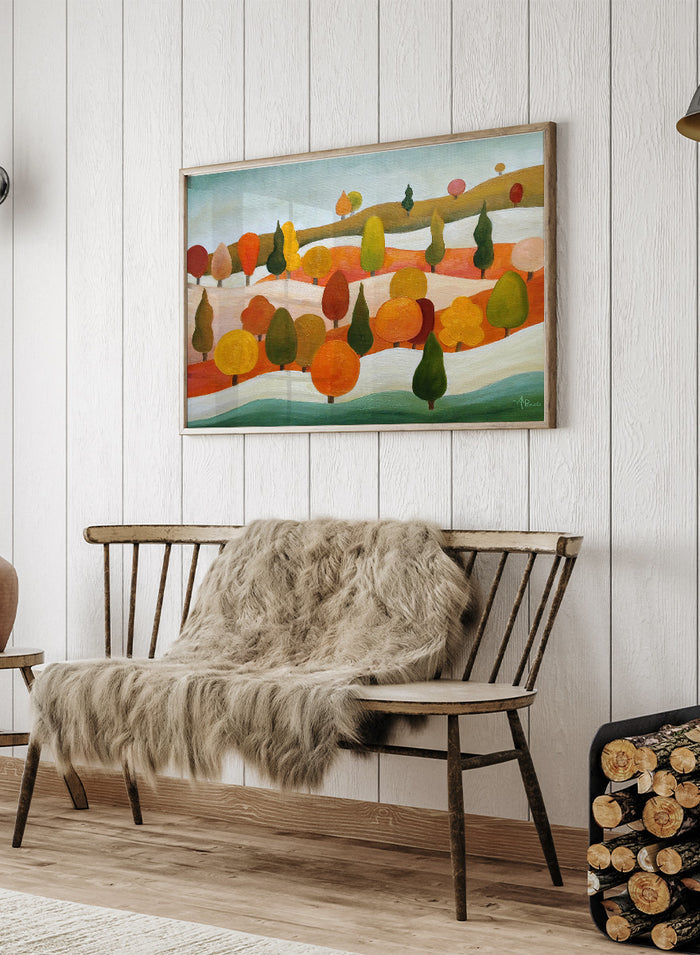 A framed landscape art print featuring stylized trees in autumn colors on rolling hills under a pale sky. Shop Colorful Autumn Hills by Angeles M. Pomata, an autumn landscape art print featuring rolling hills, stylized trees, and warm fall color.
