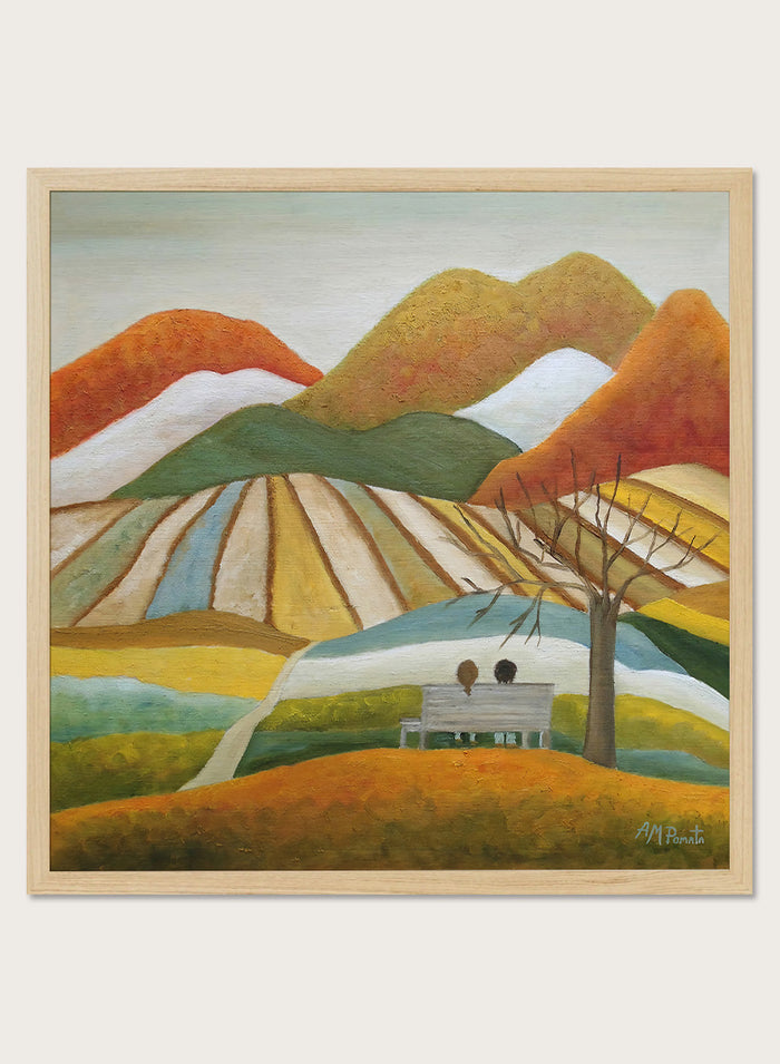 A framed landscape painting featuring stylized mountains, striped fields, a bench with two figures, and a bare tree. Shop Couple On Autumn Bench by Angeles M. Pomata, an autumn landscape and figurative art print featuring a seated couple, rolling hills, patchwork fields, and warm fall tones.