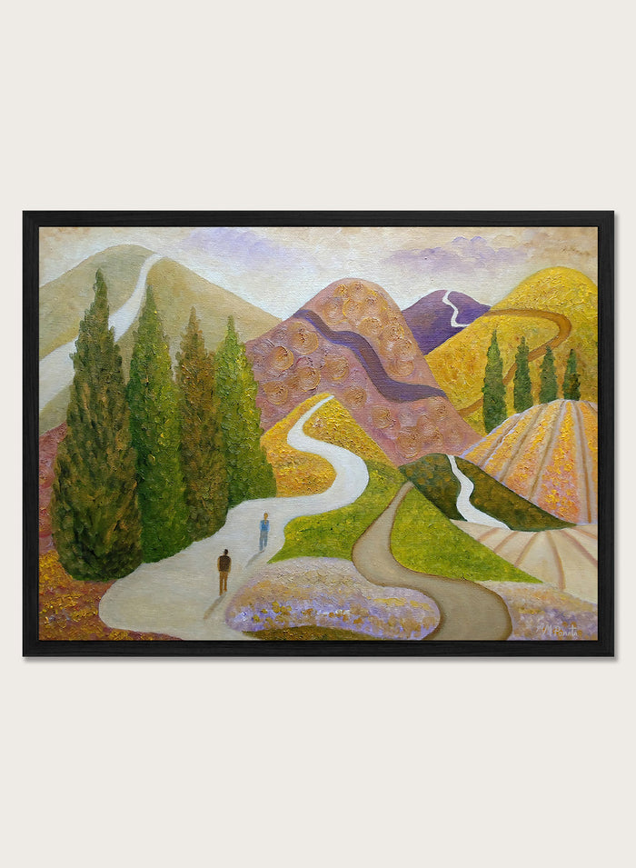 A framed landscape painting featuring stylized mountains, evergreen trees, winding paths, and small human figures, shown against a light neutral background. Shop Peaceful Journey Through Hills by Angeles M. Pomata, an autumn landscape art print featuring winding roads, cypress trees, rolling hills, and two walking figures.