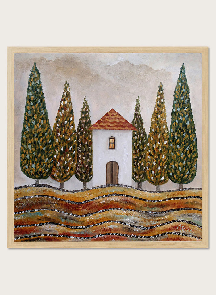 A framed landscape art print depicting a small white house with a red-tiled roof, surrounded by tall green cypress trees and wavy golden-brown hills. Shop Tuscan Cypress House by Angeles M. Pomata, an autumn landscape art print featuring a white country house, tall cypress trees, terracotta roof, and warm earthy tones.