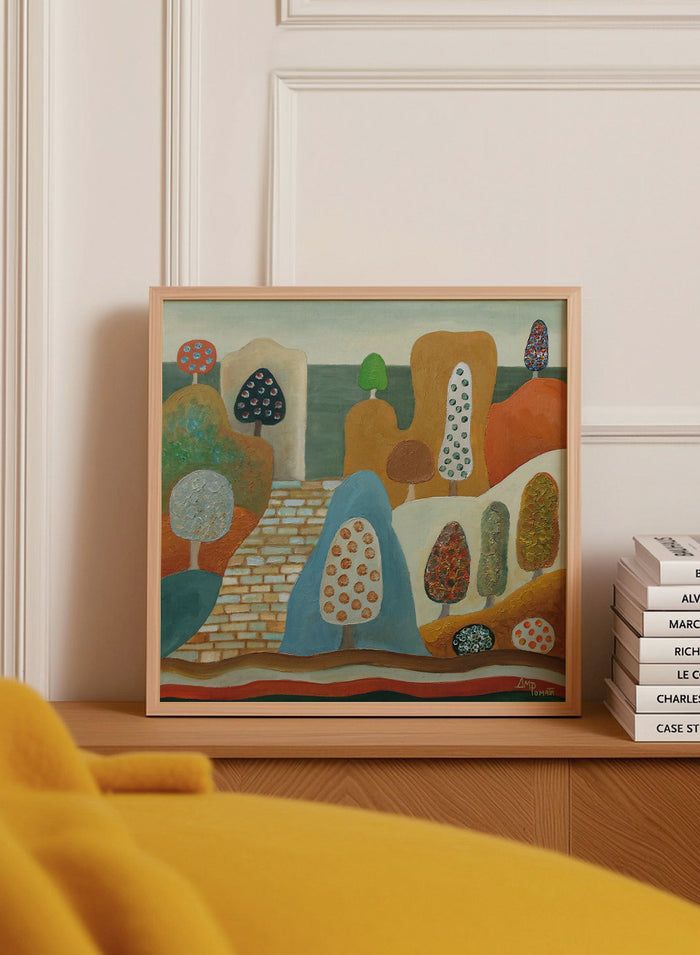A framed abstract landscape painting featuring stylized trees, hills, and geometric forms in earthy tones of orange, blue, beige, green, and brown. Shop Whimsical Tree Landscape by Angeles M. Pomata, a colorful landscape art print featuring patterned trees, rounded hills, and a winding stone path.