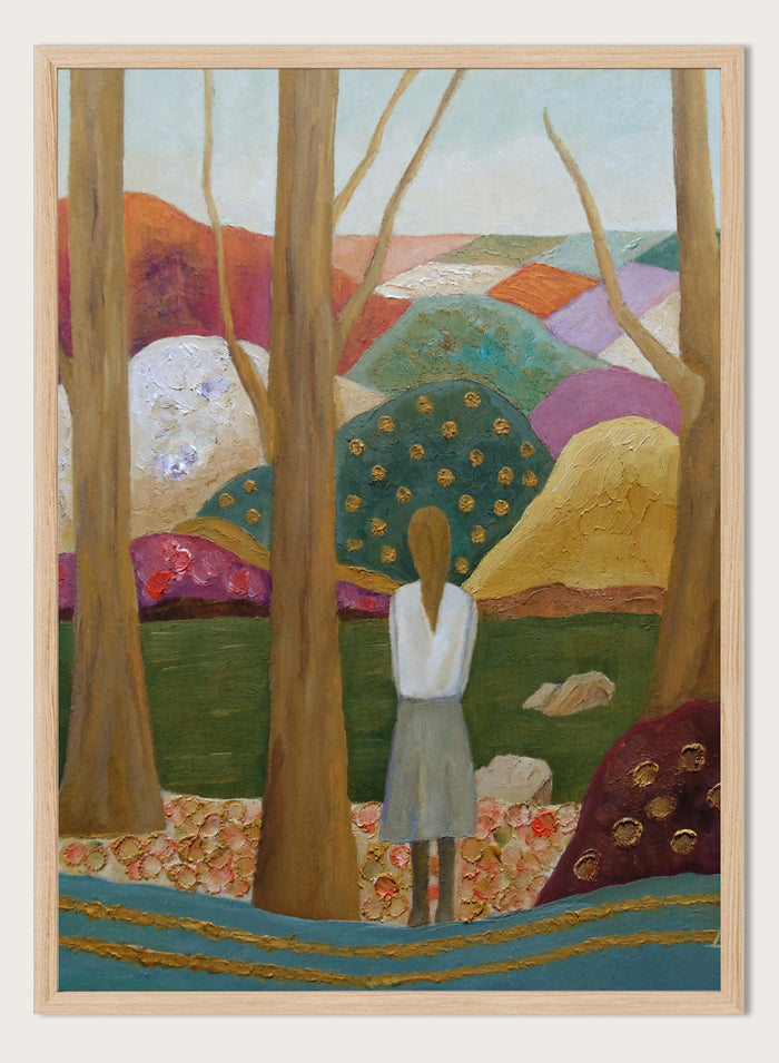 An expressive painting of a woman seen from behind standing among tall trees in a stylized landscape with colorful hills, patches of green, purple, pink, blue, and gold accents. Shop Woman Among Vibrant Hills by Angeles M. Pomata, a colorful landscape and portrait art print featuring a woman, rolling hills, trees, and earthy tones.