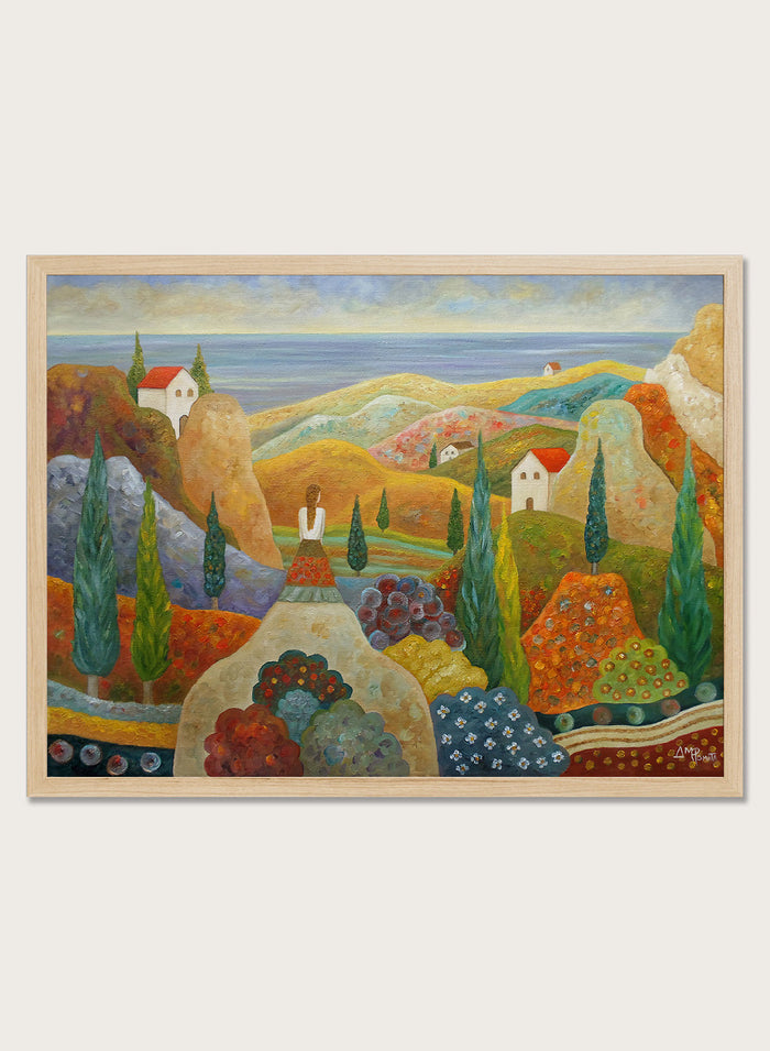 A framed landscape painting featuring stylized hills, cypress trees, small houses with red roofs, and a blue sea under a pale sky. Shop Woman in Mediterranean Landscape by Angeles M. Pomata, a colorful Mediterranean landscape and figurative art print with cypress trees, white houses, hills, and sea views.