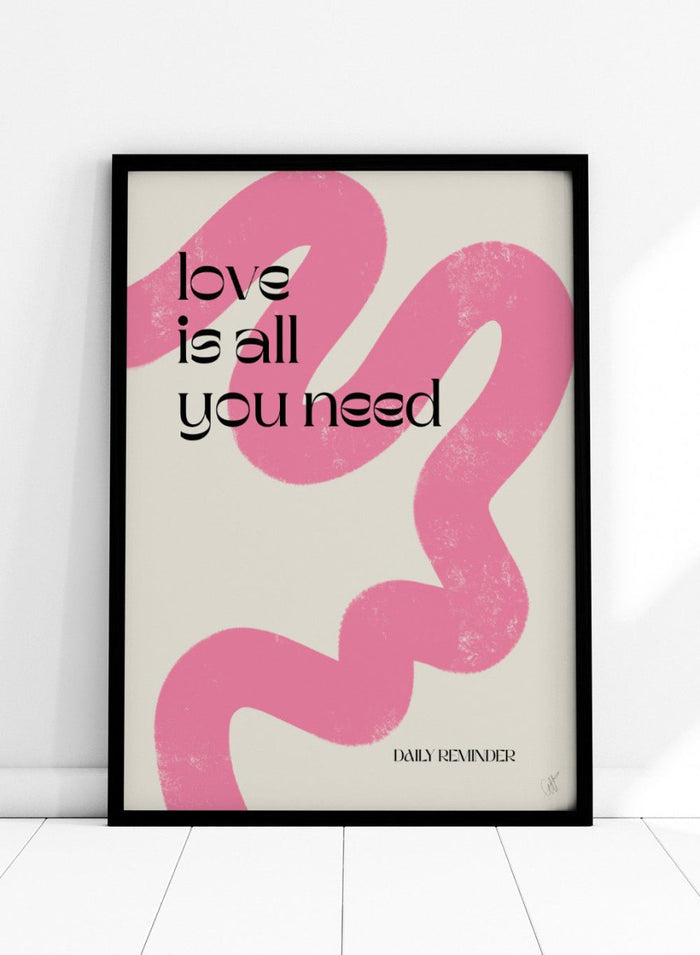 Poster with pink abstract design and 'love is all you need' text on a light background. Love Is All You Need by Anne-Marie Volfova is a typography art print with bold lettering and pink abstract brushstrokes. A modern love wall poster.