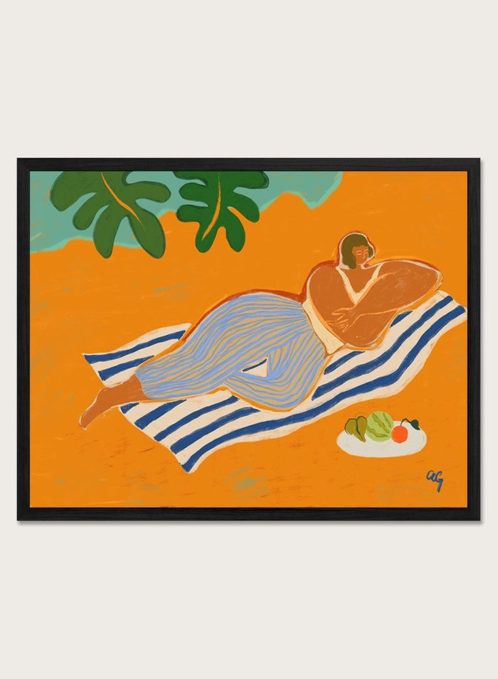 Framed artwork of a woman lounging on a towel with a plate of fruit against an orange background. A Day at the Beach by Arty Guava is a colorful coastal art print featuring a relaxed beach scene, tropical foliage, bold color, and contemporary illustration.