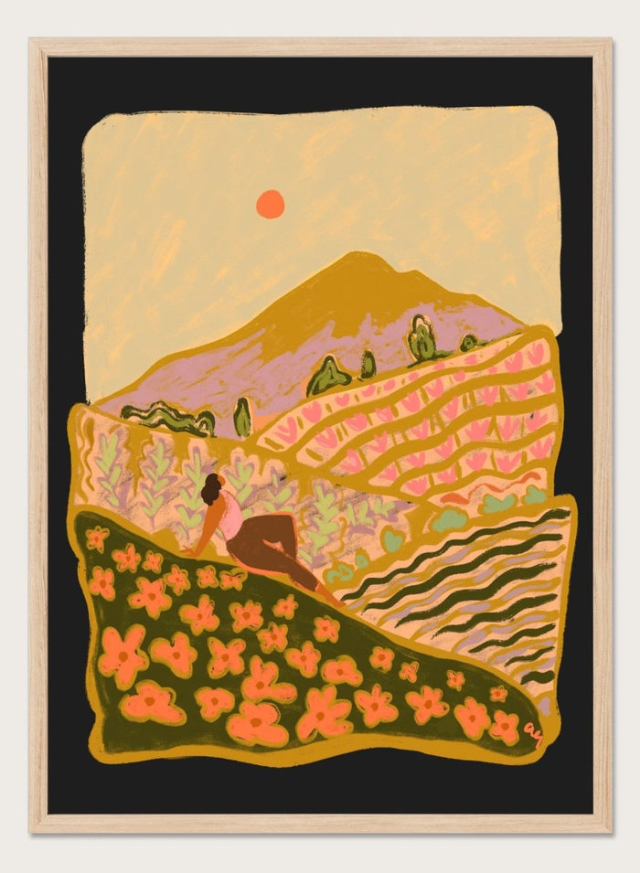 Illustration of a person sitting on a hill with a mountain and sunset in the background. Field Of Flowers by Arty Guava is a colorful landscape art print featuring blooming fields, rolling hills, nature-inspired illustration, and contemporary wall art.