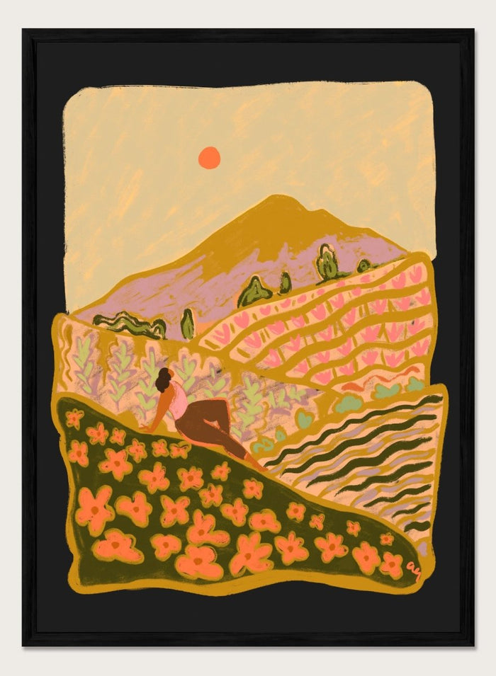 Illustration of a person sitting on a hill with a mountain and sunset in the background. Field Of Flowers by Arty Guava is a colorful landscape art print featuring blooming fields, rolling hills, nature-inspired illustration, and contemporary wall art.
