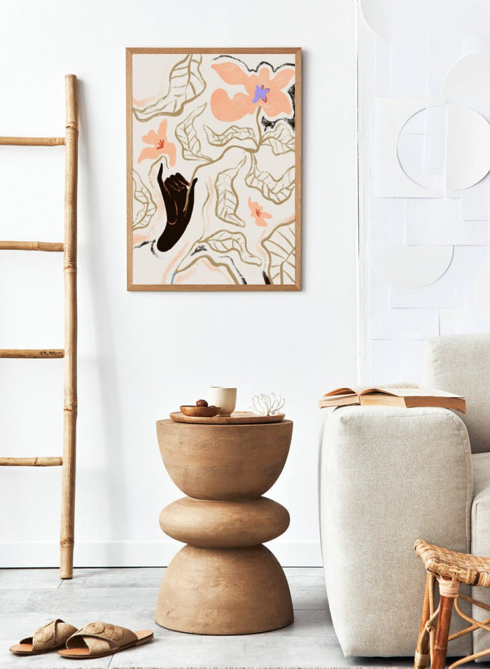 Abstract artwork with a black hand reaching towards flowers on a light background. Fleur by Arty Guava is a modern floral art print with soft abstract flowers and hand-drawn linework. Officially licensed wall poster with framing.