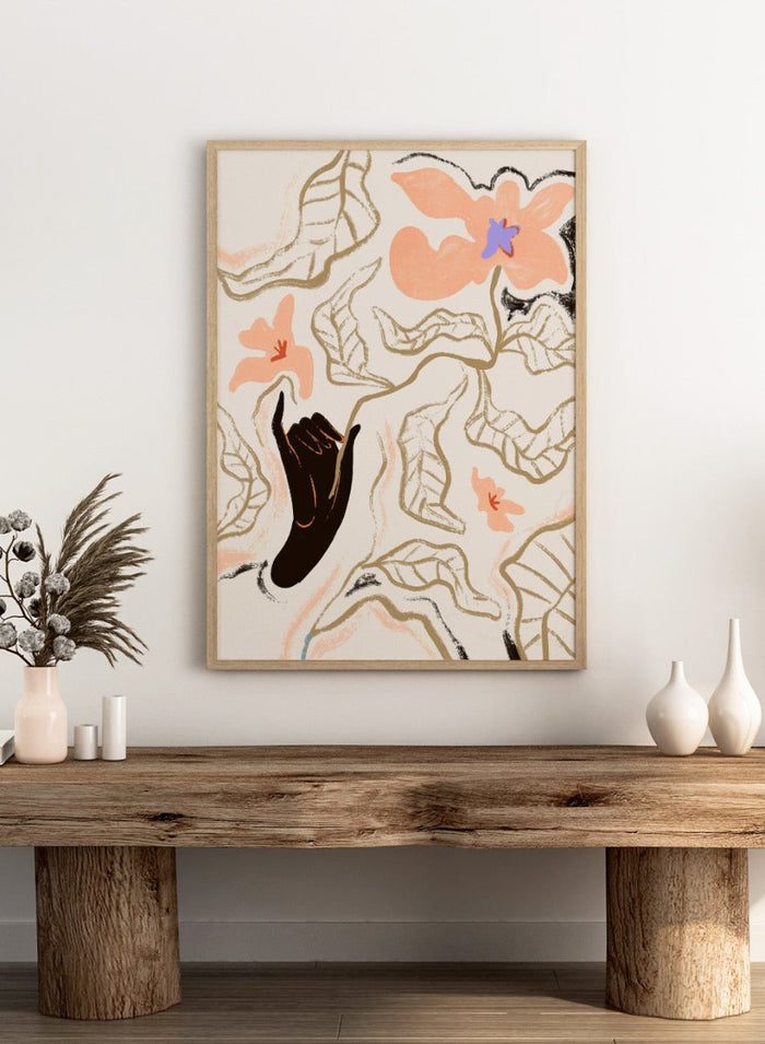 Abstract artwork with a black hand reaching towards flowers on a light background. Fleur by Arty Guava is a modern floral art print with soft abstract flowers and hand-drawn linework. Officially licensed wall poster with framing.