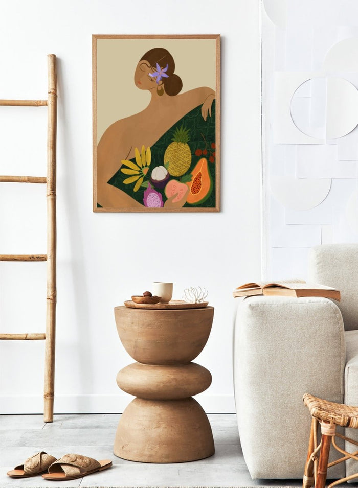 Illustration of a woman with a green wrap featuring tropical fruits on a beige background. Fruit Seller by Arty Guava is a colorful tropical art print featuring exotic fruit, expressive female figures, bold color, and contemporary illustration.