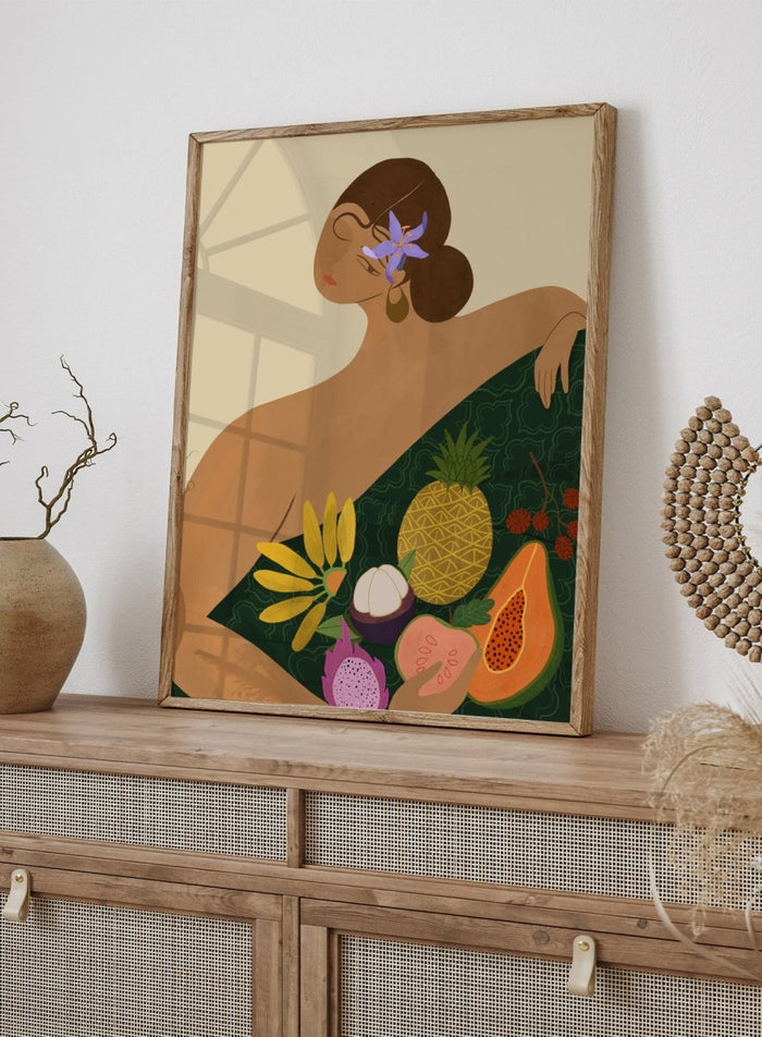 Illustration of a woman with a green wrap featuring tropical fruits on a beige background. Fruit Seller by Arty Guava is a colorful tropical art print featuring exotic fruit, expressive female figures, bold color, and contemporary illustration.