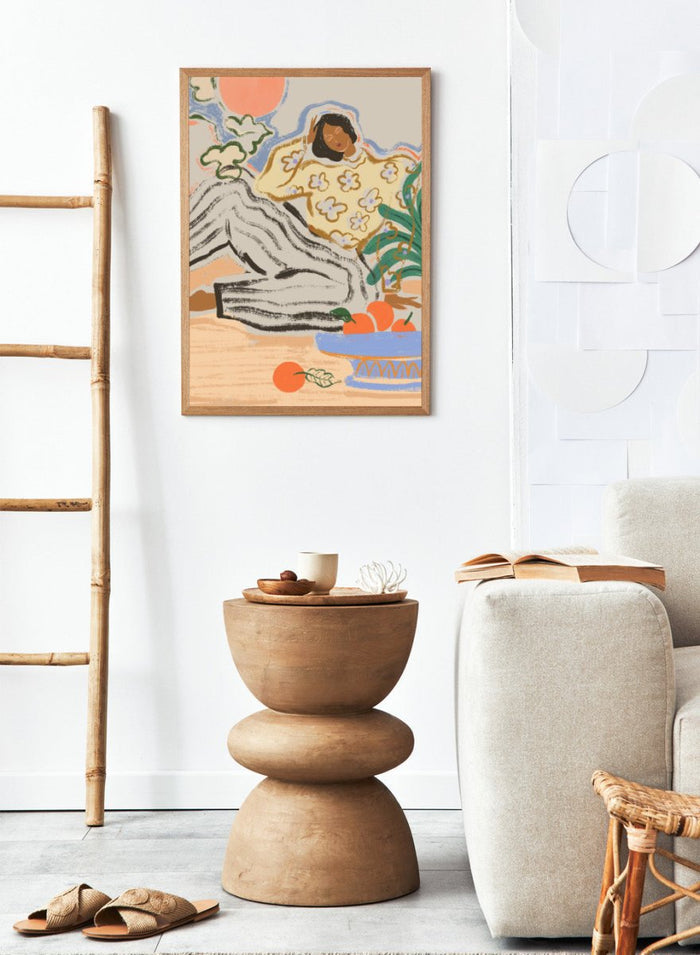 Artistic depiction of a person lounging on a beach with a bowl of fruit and flowers. Lazy Days by Arty Guava is a modern woman art print with warm colors, oranges, and relaxed still life details. Officially licensed wall poster.