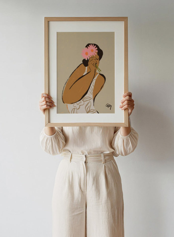 Illustration of a person holding a pink flower to their face against a beige background. Mask by Arty Guava art print, modern woman illustration holding flowers, contemporary figurative wall poster in soft neutral tones.