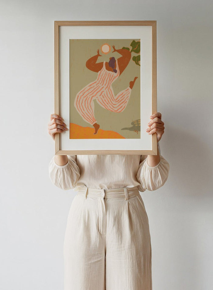 Artistic depiction of a person in overalls reaching towards the sun on a beige background. Reach For The Sun by Arty Guava is a vibrant modern art print of a woman stretching toward the sun. Officially licensed wall poster with framing.