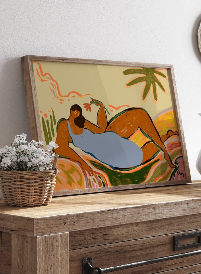 Framed artwork of two abstract figures embracing with a tropical background. Rest and Relax by Arty Guava is a colorful contemporary art print featuring a reclining female figure, tropical motifs, bold color, and nature-inspired illustration.