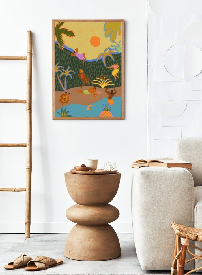A colorful tropical beach illustration featuring stylized figures relaxing on a sandy shore, swimming in blue water, lounging under palm trees, with a yellow sky and orange sun. Summer Paradise by Arty Guava premium framed fine art print featuring women swimming, dancing, and relaxing in a vibrant tropical landscape.