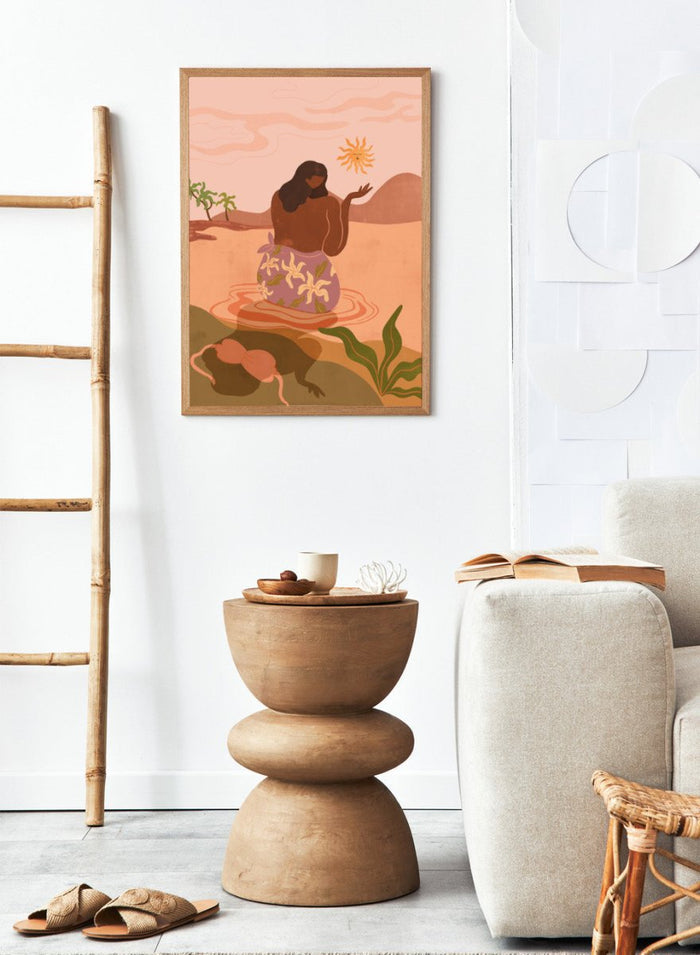 Illustration of a woman in a floral dress sitting by a pool with a sun and desert landscape in the background. Sunset by Arty Guava art print, modern woman illustration wall poster in warm pink tones, contemporary nature landscape artwork.