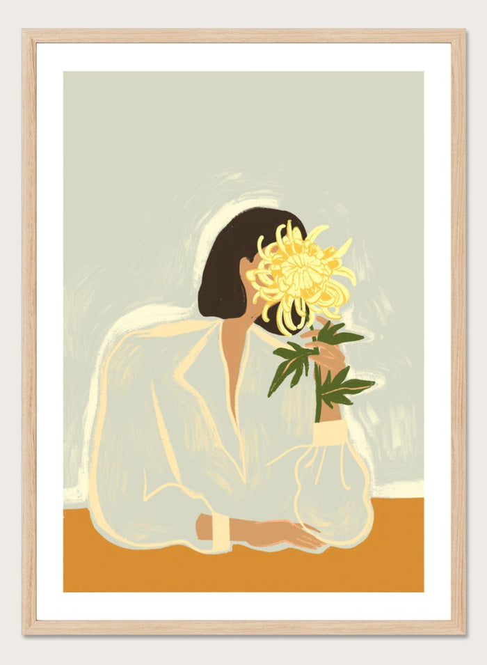 Illustration of a woman in a white dress holding a large yellow flower against a light background. The Chrysanthemum by Arty Guava is a modern portrait illustration featuring a woman with flowers, contemporary floral wall art style, and officially licensed artwork.