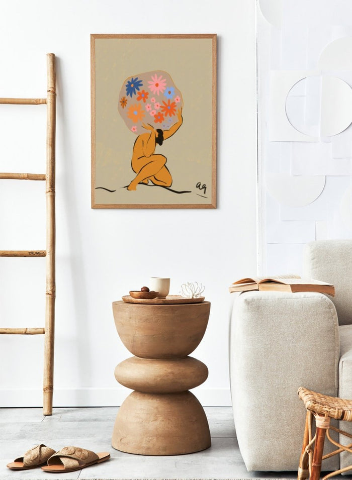 Surreal artwork of a figure holding a globe filled with colorful flowers on a beige background. World On Her Shoulders by Arty Guava is a colorful contemporary art print featuring a floral globe, expressive female figure, empowerment, and modern illustration.