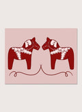 Two red Dala horse figures with white patterns on a pink background. Nordic Horses Twins by Athene Fritsch is a Scandinavian folk art illustration art print featuring Swedish Dala horses, bold red color, and modern wall art design.