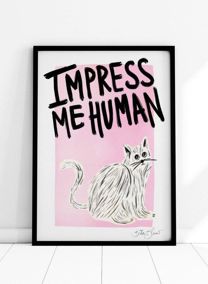 Cartoon cat with 'Impress Me Human' text on a pink background. Cat Owner. Impress Me Human by Baroo Bloom is a playful cat art print featuring hand-drawn illustration and humorous typography. Officially licensed wall poster with optional framing.