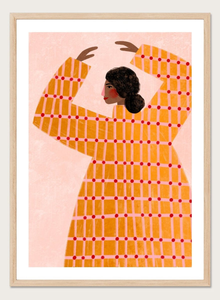 A framed art print featuring a stylized illustration of a woman in profile wearing a bright orange dress with a red grid pattern, set against a pale pink background. Dancing Woman in Orange by Bea Müller premium fine art print featuring a bold figure, warm orange tones, and a playful graphic composition.