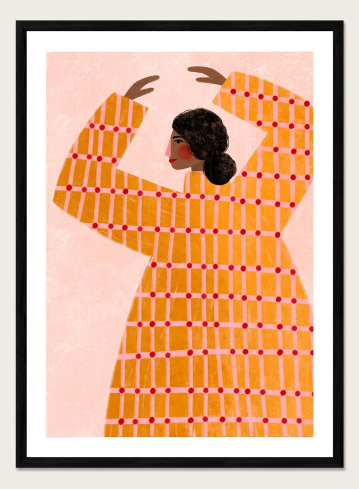 A framed art print featuring a stylized illustration of a woman in profile wearing a bright orange dress with a red grid pattern, set against a pale pink background. Dancing Woman in Orange by Bea Müller premium fine art print featuring a bold figure, warm orange tones, and a playful graphic composition.