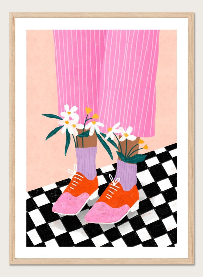 A stylized fashion illustration of a person's legs wearing pink pinstripe trousers, lavender socks, orange and pink shoes, and holding white flowers, set against a peach background with a black-and-white checkered floor. Flowering Oxford Style by Bea Müller premium framed fine art print featuring colorful Oxford shoes, lilac socks, and flowers on a checkered floor.