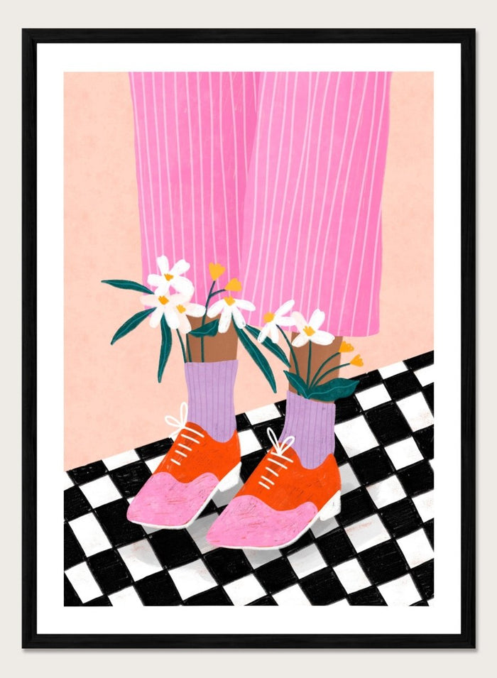 A stylized fashion illustration of a person's legs wearing pink pinstripe trousers, lavender socks, orange and pink shoes, and holding white flowers, set against a peach background with a black-and-white checkered floor. Flowering Oxford Style by Bea Müller premium framed fine art print featuring colorful Oxford shoes, lilac socks, and flowers on a checkered floor.