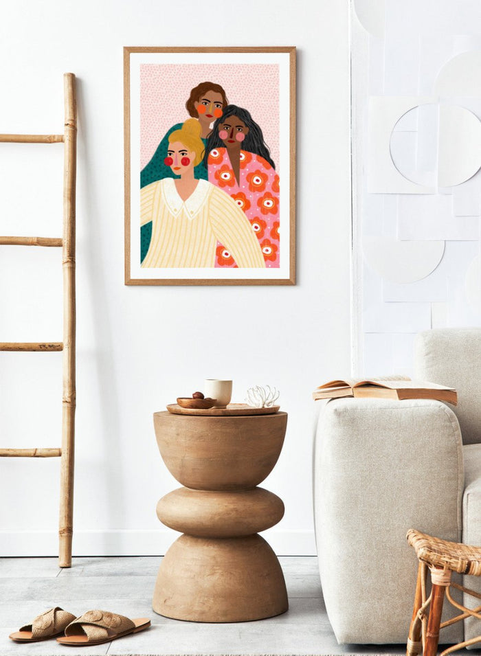 Illustration of three women with colorful clothing and patterns on a pink background. Girl Friends by Bea Müller is an officially licensed art print featuring three women illustrated in her signature bold colors and modern expressive style.