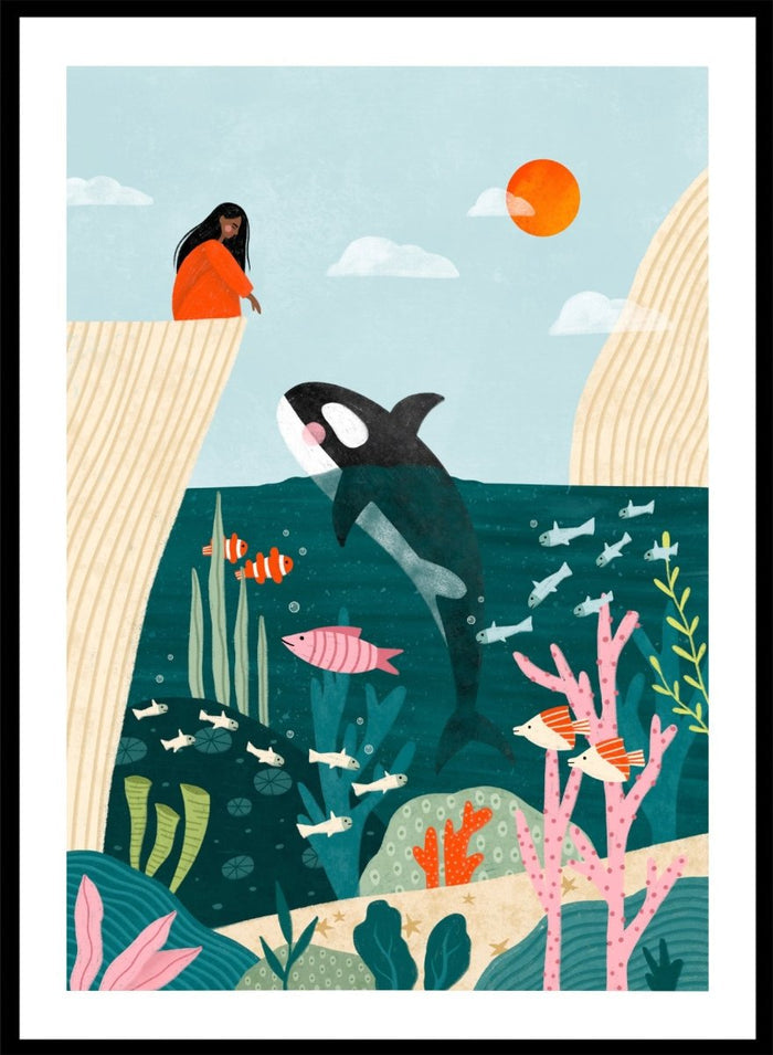A framed art print featuring a whimsical underwater scene with an orca, coral, fish, and a woman in an orange dress standing on a cliff edge under a sun. Girl Watches Ocean Life by Bea Müller premium framed fine art print featuring a child watching an orca swim through a colorful underwater world.