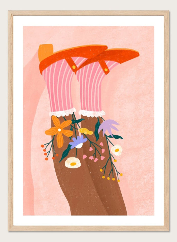 A stylized art print featuring a pair of legs wearing pink striped socks with white ruffles, decorated with colorful wildflowers, and topped with orange high-heeled shoes, set against a textured pink background. Happy Feet and Flowers by Bea Müller premium framed fine art print featuring red Mary Janes, striped socks, and colorful flowers on a soft pink background.