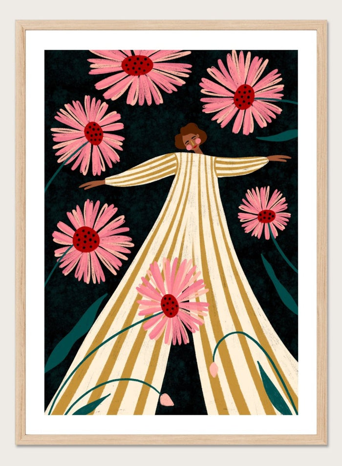 A framed art print featuring a stylized illustration of a woman in a cream and gold striped dress surrounded by large pink flowers on a dark background. Joyful Woman In Bloom by Bea Müller premium framed fine art print featuring a woman in a striped dress surrounded by oversized pink flowers.