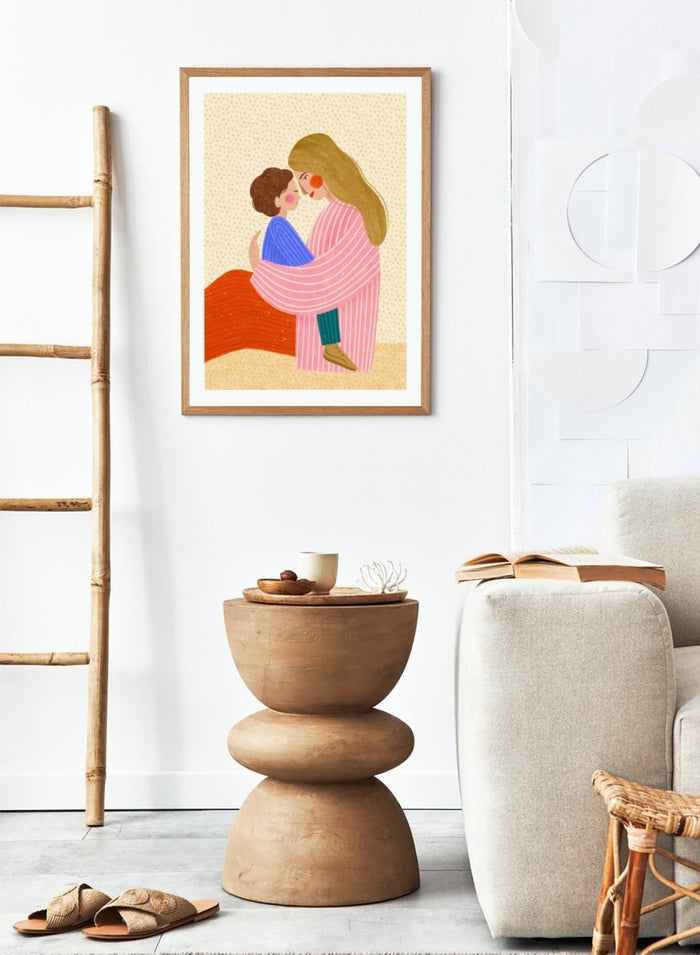 A framed art print featuring a stylized illustration of a woman in a pink striped robe embracing a child in a blue sweater. Loving Mother Child Embrace by Bea Müller premium framed fine art print featuring a mother holding her child close in warm, colorful tones.