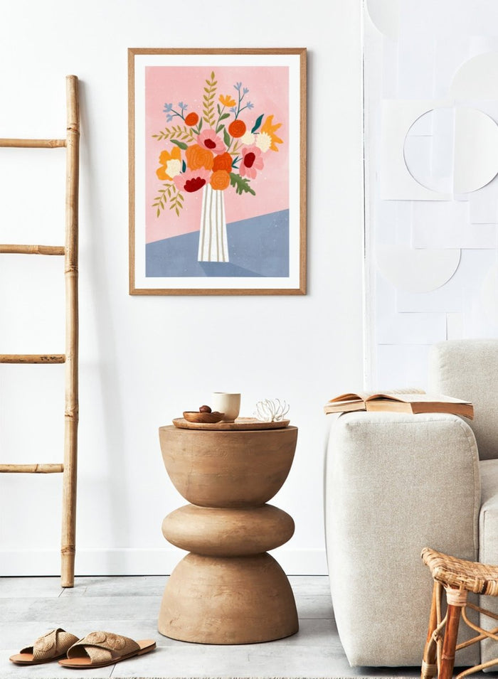 A framed art print featuring a colorful, stylized illustration of a flower bouquet in a striped vase against a pink and blue background. Modern Floral Arrangement by Bea Müller premium framed fine art print featuring a colorful bouquet in a striped vase on a soft pink background.
