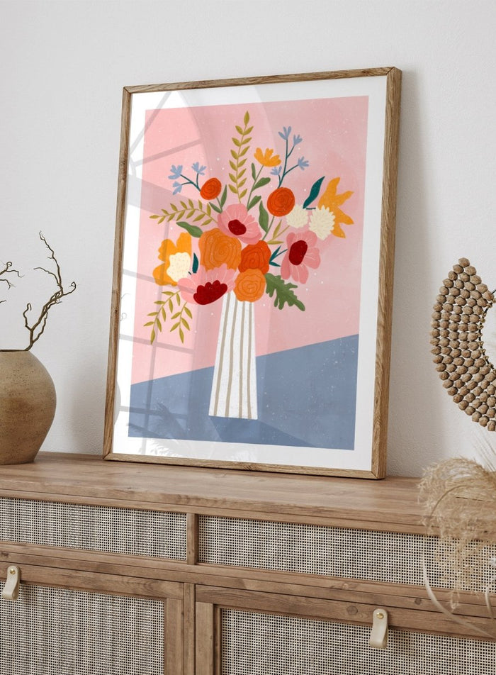 A framed art print featuring a colorful, stylized illustration of a flower bouquet in a striped vase against a pink and blue background. Modern Floral Arrangement by Bea Müller premium framed fine art print featuring a colorful bouquet in a striped vase on a soft pink background.