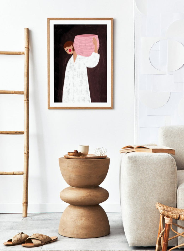 The Woman With the Pink Basket by Bea Müller is an officially licensed art print featuring a modern illustrated figure with soft color contrast and a calm, grounded feel. Available framed or unframed.