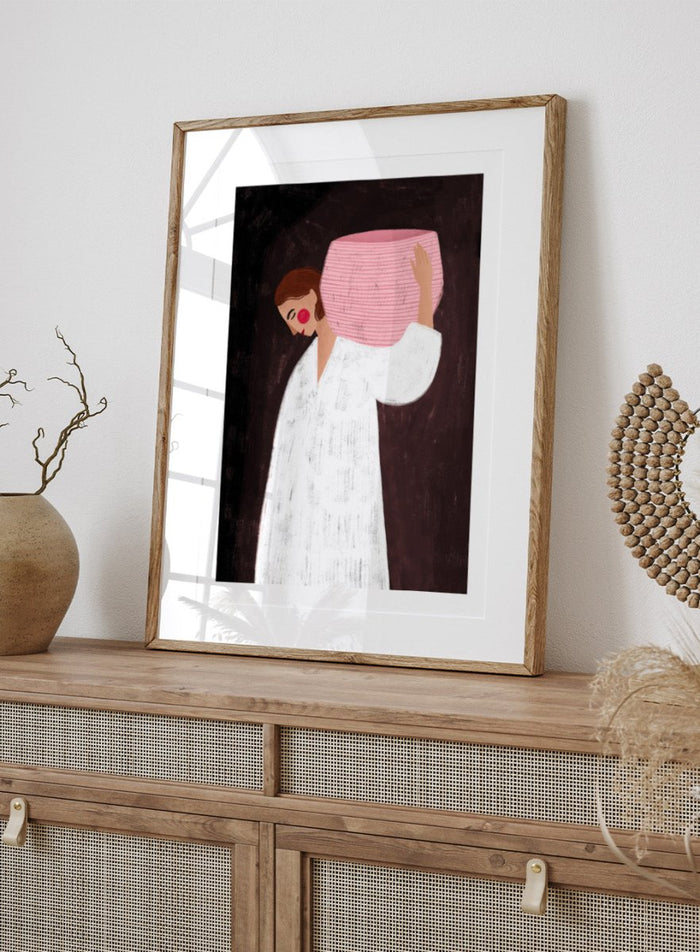 The Woman With the Pink Basket by Bea Müller is an officially licensed art print featuring a modern illustrated figure with soft color contrast and a calm, grounded feel. Available framed or unframed.