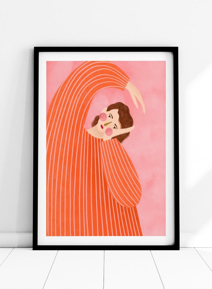 A framed art print featuring a stylized illustration of a woman in a flowing orange and white striped dress, posed in a graceful arch against a soft pink background. Thoughtful Girl in Stripes by Bea Müller premium framed fine art print featuring a woman in an oversized orange striped top against a soft pink background.