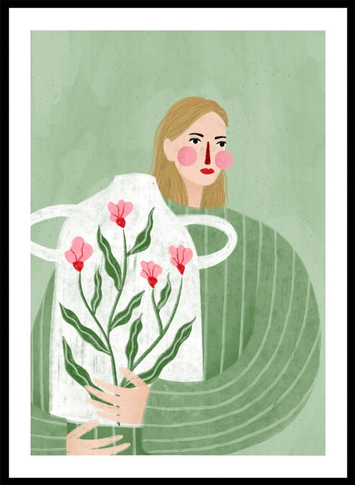 A framed art print featuring a stylized illustration of a woman with blonde hair holding a white apron decorated with pink flowers and green leaves, set against a sage green background. Woman Holding Flowers by Bea Müller premium framed fine art print featuring a woman carrying a white vase filled with pink flowers and green leaves.