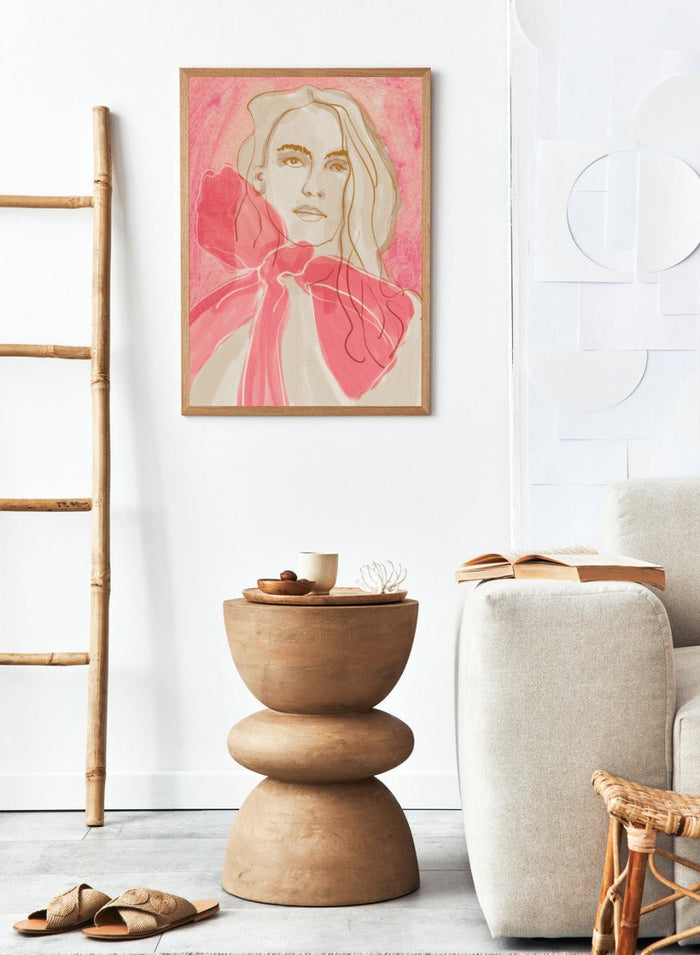 Artistic illustration of a woman with a pink bow tie on a pink background. Ethereal Red by Beate Tubach is a modern portrait art print featuring expressive linework and flowing red tones. A contemporary figurative wall poster.